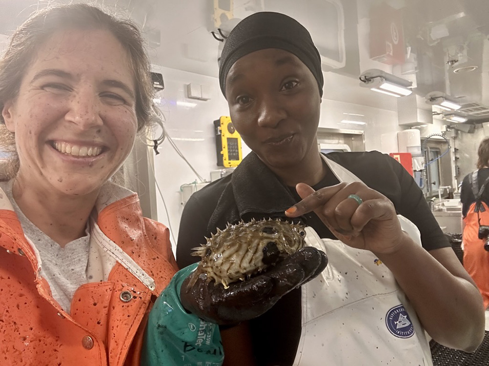 Kate Bemis excited about a burrfish caught off west Africa in March, 2025, with Khoudia Khaya, Senegal. Photo credit: Katherine Bemis.