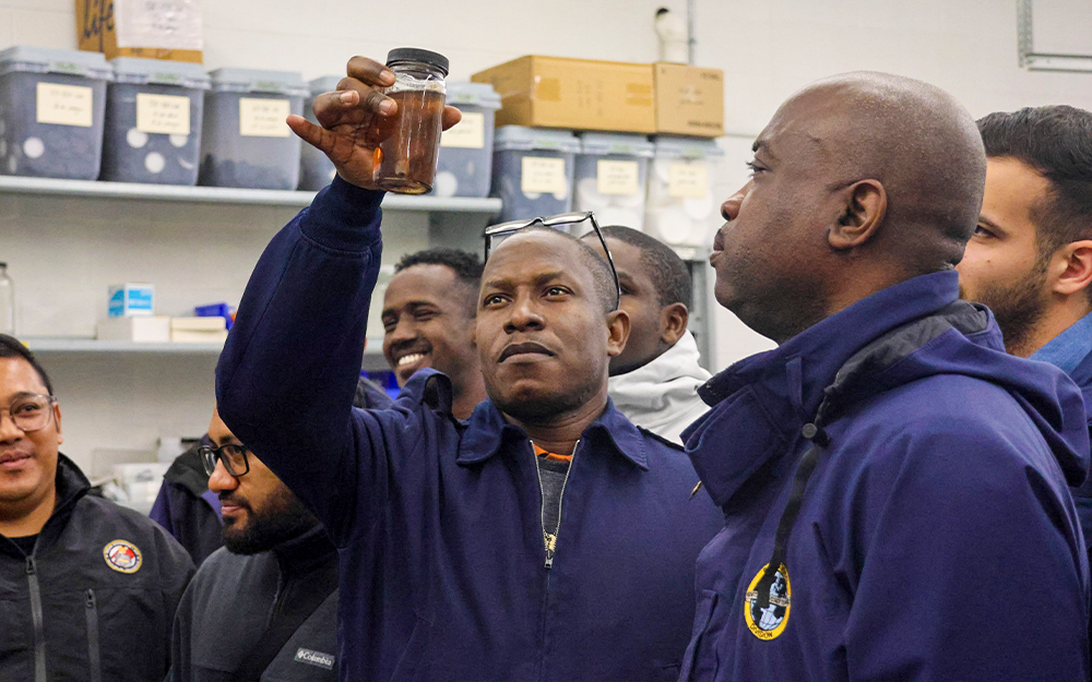 A USCG IMOC participant examines a preserved specimen.