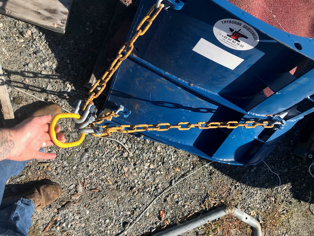 blue trawl door with backstrap chains, master link, extension wire, and bow shackle